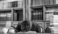 Guy is overworked and sleeps on table.