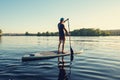 Guy paddling on a SUP board on large river