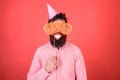 Guy in party hat celebrates, posing with photo props. Hipster in giant sunglasses celebrating. Man with beard on