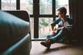 Guy plaing on guitar sits on the floor at home Royalty Free Stock Photo