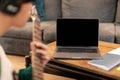 Guy Playing Electric Guitar Near Laptop With Blank Screen Indoors Royalty Free Stock Photo