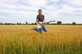 Guy Playing Electric Guitar In Wheat Field Royalty Free Stock Photo