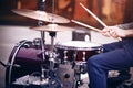 Guy playing rhythm on a red drum set with drumsticks Royalty Free Stock Photo