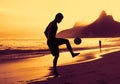 Guy playing soccer at beach at Rio at sunset Royalty Free Stock Photo