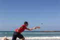 The guy playing tennis on the beach