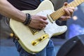 Guy plays an electric guitar in open air. Close up Royalty Free Stock Photo