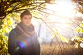 Guy portrait against an autumn tree in a park Royalty Free Stock Photo