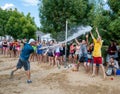 The guy pours water from a bucket in a summer camp