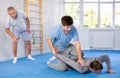 Guy practicing armlock in training bout during self-defence course