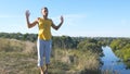 Guy practicing yoga moves and positions outdoors. Young man standing at yoga pose at nature. Athlete doing strength Royalty Free Stock Photo