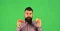 Guy presents homegrown harvest. Man with beard holds red apples