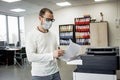 Guy in protective mask  copies documents Royalty Free Stock Photo