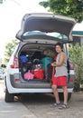 Guy puts the bag in the luggage of the car during the departure Royalty Free Stock Photo