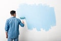 Guy puts first layer of blue paint Royalty Free Stock Photo