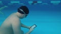 The guy is reading an electronic book underwater. Royalty Free Stock Photo