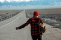 Guy in red hitchhiking down on lonesome road Royalty Free Stock Photo