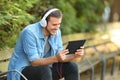 Guy relaxing watching videos on line in a tablet