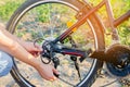 The guy repairs the bicycle. chain repair. cyclist. unratitude on the road, travel, close-up.