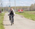 A guy riding a bike on rural roads Royalty Free Stock Photo