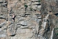 Guy`s climbing rocks and looks in top, extreme. Crested surface, in cracks. Rock. Stone walls. fearless person