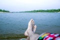 Guy`s feet, by the river, enjoy the beach holiday, high and relaxation Royalty Free Stock Photo