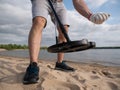 Guy on a sandy coast looking for treasure with a metal detector on a sunny summer day Royalty Free Stock Photo