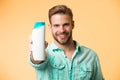 Guy satisfied with this shampoo. Man bearded stylish holds plastic bottle. Guy handsome care about appearance use Royalty Free Stock Photo