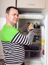 Guy searching for something in refrigerator Royalty Free Stock Photo