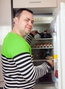 Guy searching for something in refrigerator Royalty Free Stock Photo