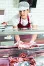 Guy seller works in specialized butcher shop
