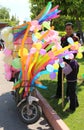 Guy selling Colorful Cotton Candy and Balloons on a scooter at Orange Blossom Carnival Royalty Free Stock Photo