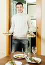 Guy serving festive table with fish Royalty Free Stock Photo