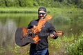 One guitarist set fire to his guitar near a river Royalty Free Stock Photo