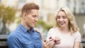 Guy showing engagement ring to girlfriend, happy girl accepting proposal