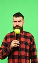 Guy shows harvest product. Man holds glass of apple juice