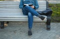 Guy sitting on a bench legs crossed