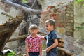 The guy is sitting near the ruined house, the concept of a natural disaster. Royalty Free Stock Photo