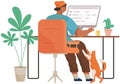 Guy sitting at workplace with pet. Freelancer with laptop working and spending time with cat