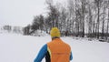 Guy skier on a ski base in a snowy forest