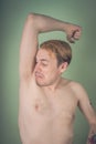 Guy sniffs his armpits Royalty Free Stock Photo