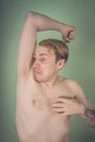Guy sniffs his armpits Royalty Free Stock Photo