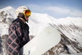 Snowboarder walking with a snowboard in the winter. Ski touring in the snowy mountains on a sunny day Royalty Free Stock Photo