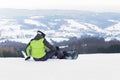 Guy snowboarder stand on the background of snow-capped mountains, preparing for slalom. Modern sports equipment for winter sports