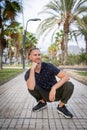 Guy squirts in the middle of the pavement, he is smiling calm and carefree. Portrait of a 30 year old bisexual Caucasian man