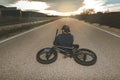 Guy standing bmx bike. BMX rider with and a sunset. Extreme urban sports Royalty Free Stock Photo