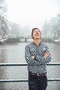 Guy is standing on a bridge