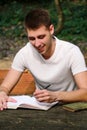 Guy and student takes notes in notebook, learning and writes thoughts, writes the book, he is preparing his final exams. Royalty Free Stock Photo