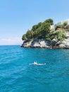 The guy is swimming in the beautiful blue Aegean Sea. Kusadasi, Turkey. Royalty Free Stock Photo