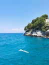 The guy is swimming in the beautiful blue Aegean Sea. Kusadasi, Turkey. Royalty Free Stock Photo