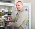 Guy taking food from refrigerator Royalty Free Stock Photo